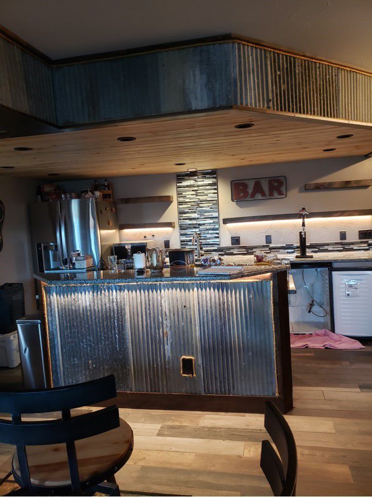 A kitchen with a metal bar and a sign that says bar.