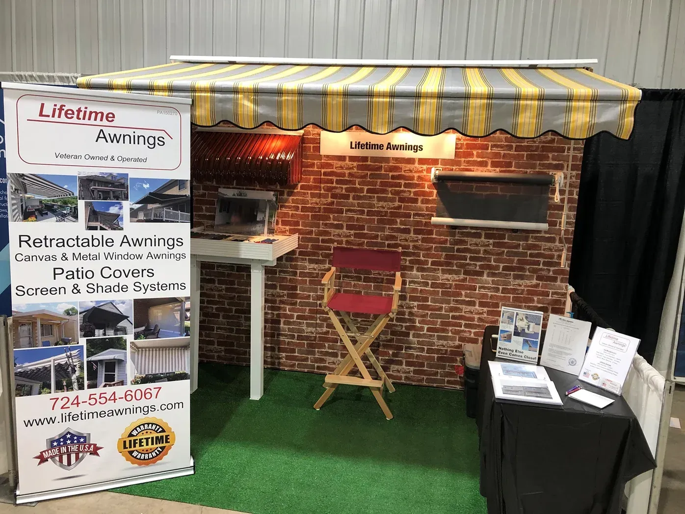 Booth for Lifetime Awnings at a trade show, showcasing retractable awnings.
