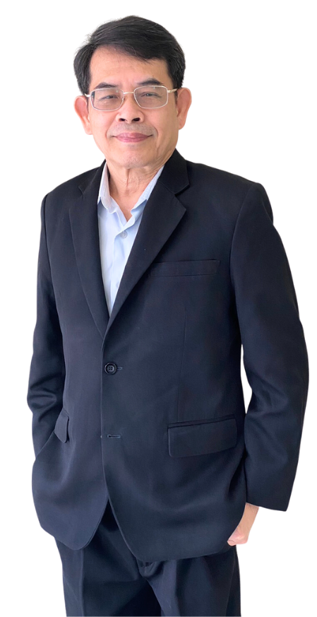 A man in a suit and glasses is standing with his hands in his pockets.