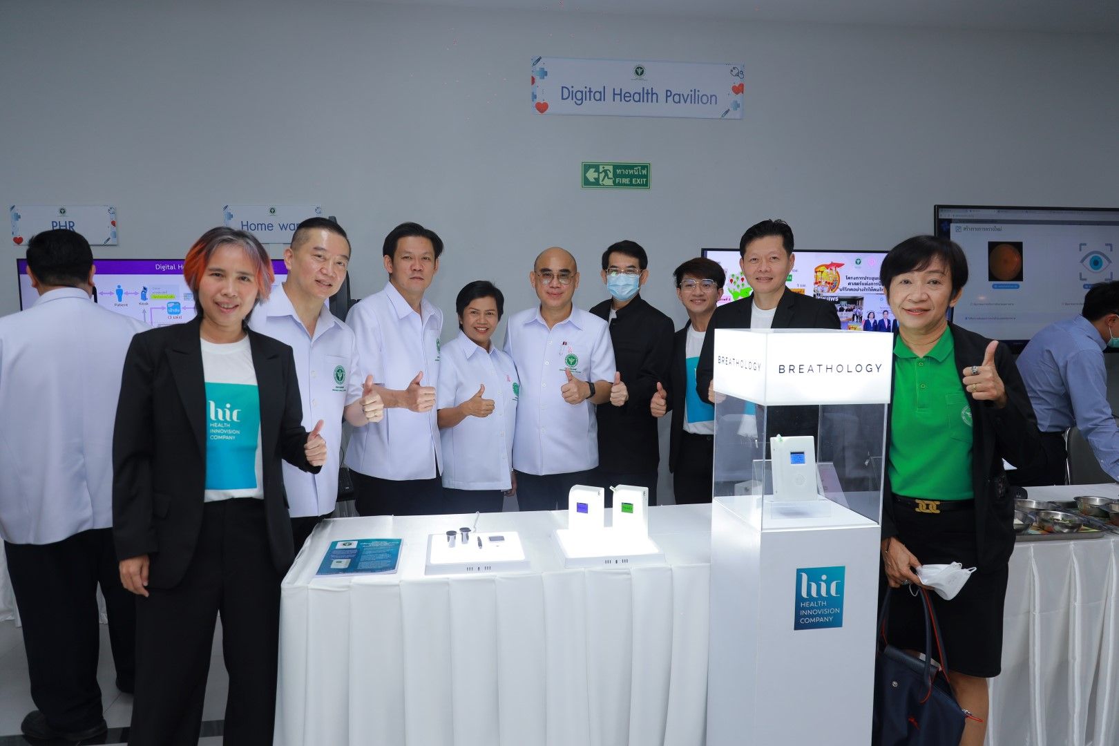 A group of people are posing for a picture in front of a table.