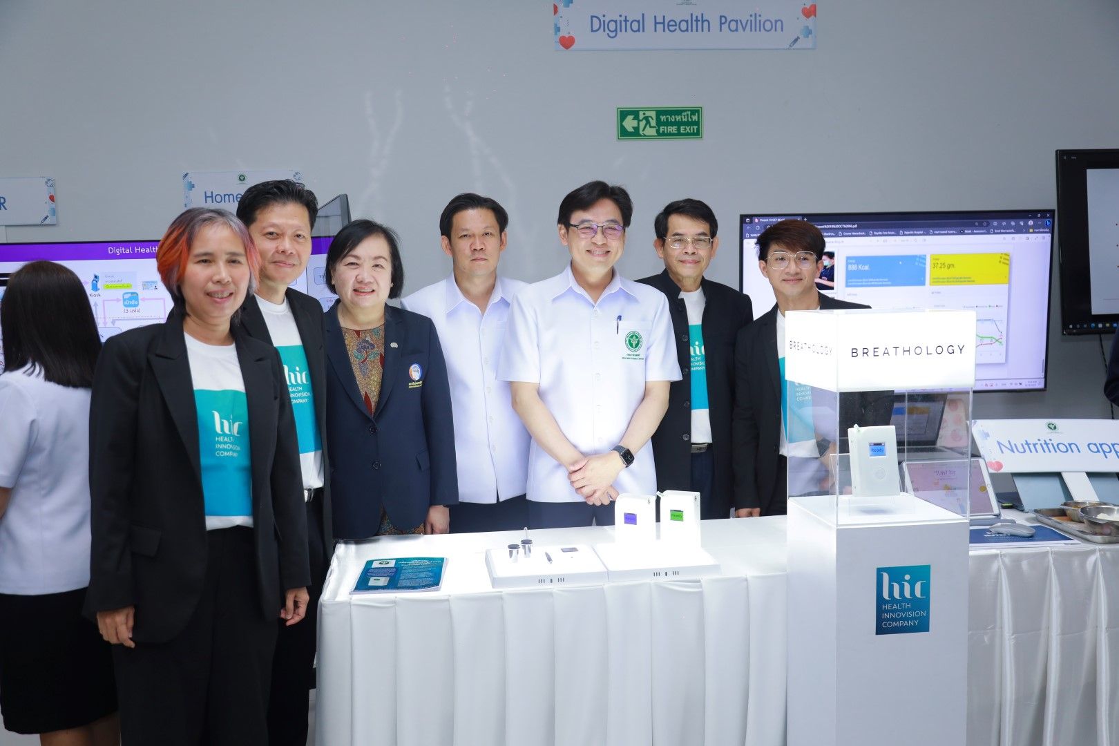 A group of people are posing for a picture in front of a table.