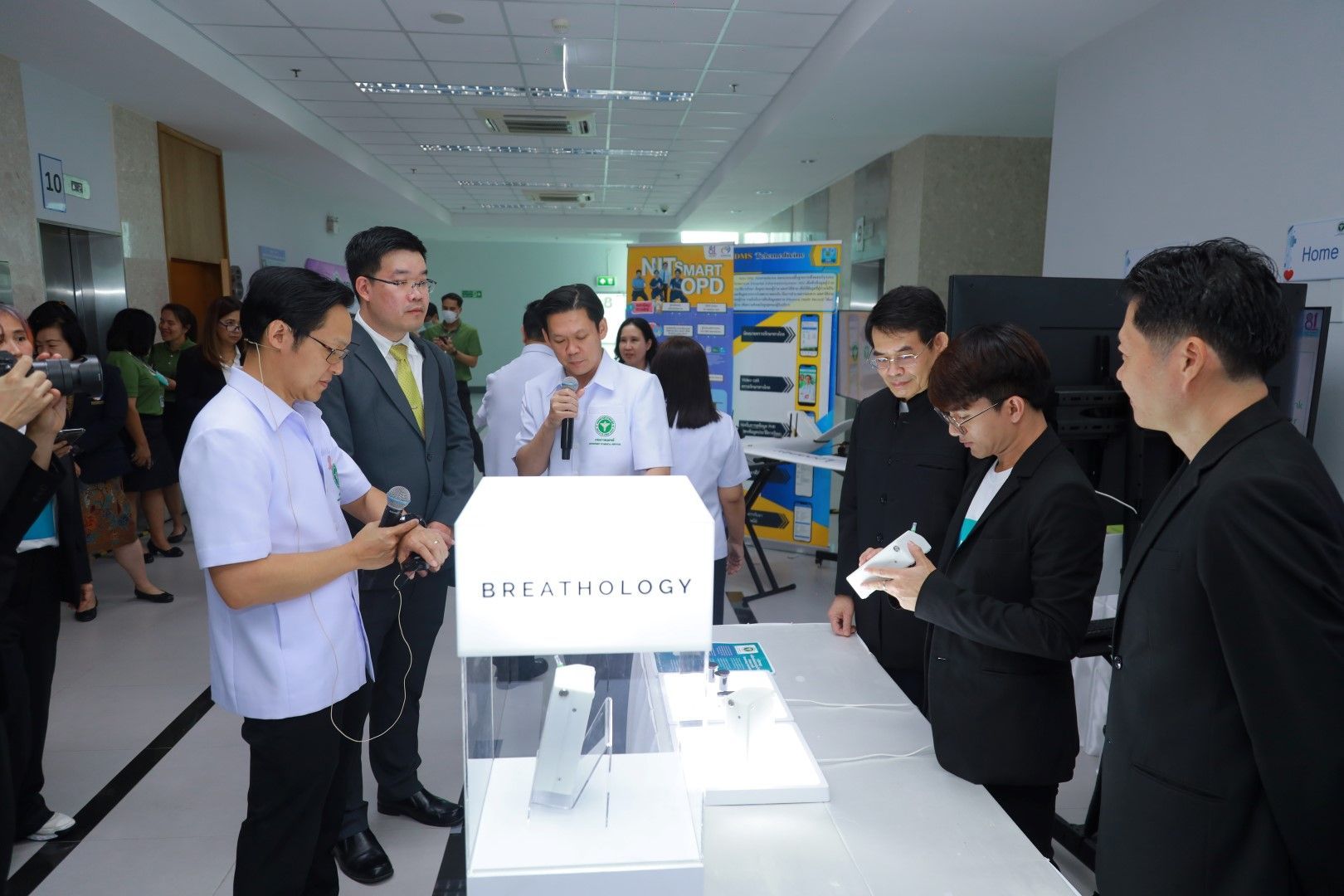 A group of people are standing around a table in a room.