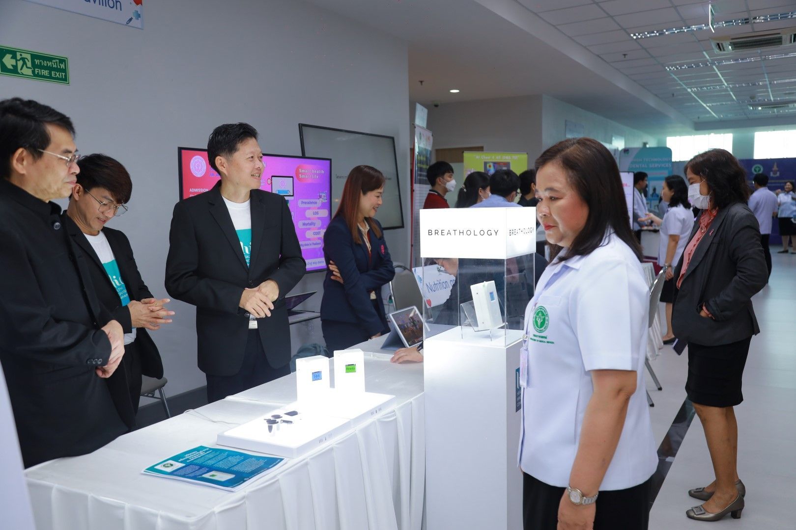 A group of people are standing around a table in a room.