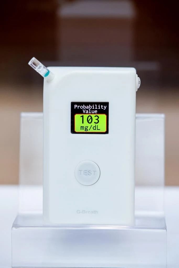 A white device with a screen that says 103 on it