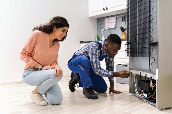 A living room is flooded with water and a couch and chair are floating in the water.
