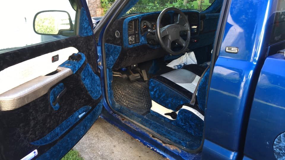 The inside of a blue truck with the door open.