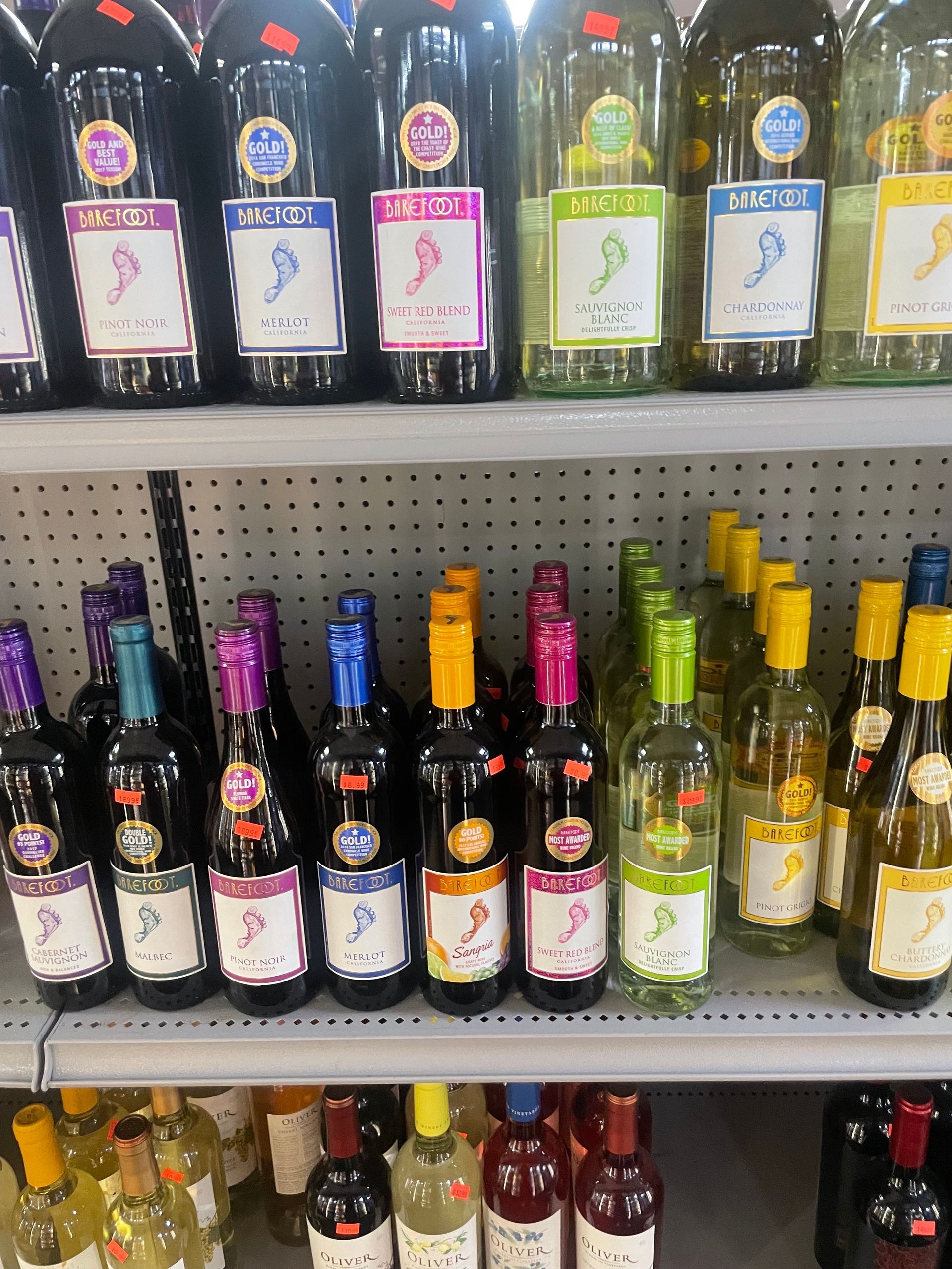 Several Bottles of Barefoot Wine Are Lined up On a Shelf
