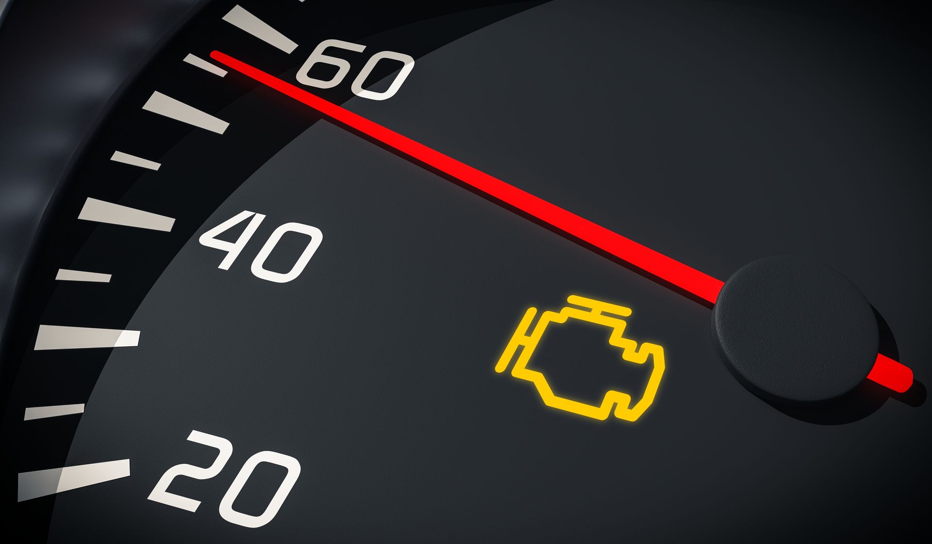 A yellow check engine light illuminated on a dark car dashboard speedometer.