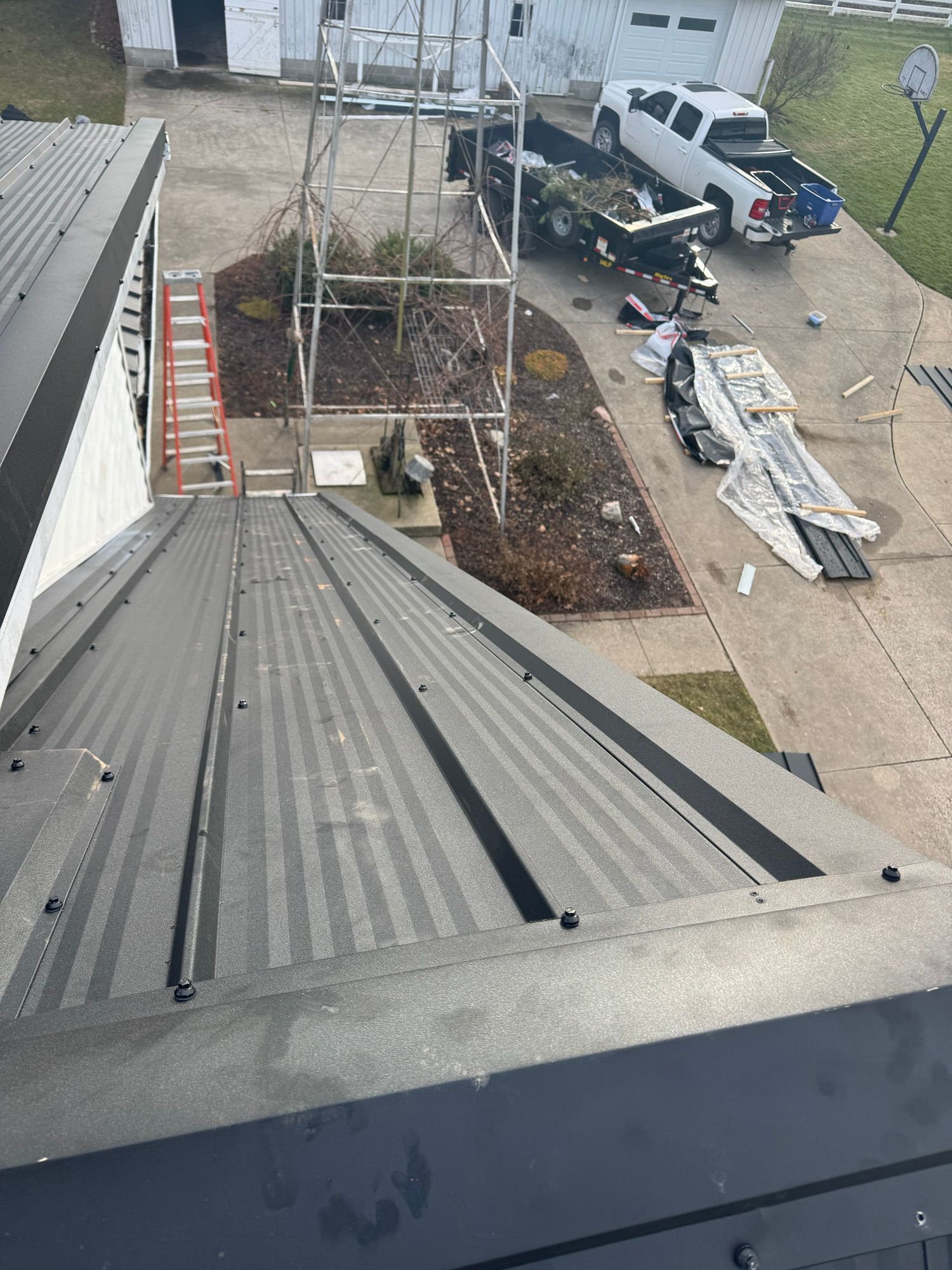 An aerial view of a roof being installed on a house.