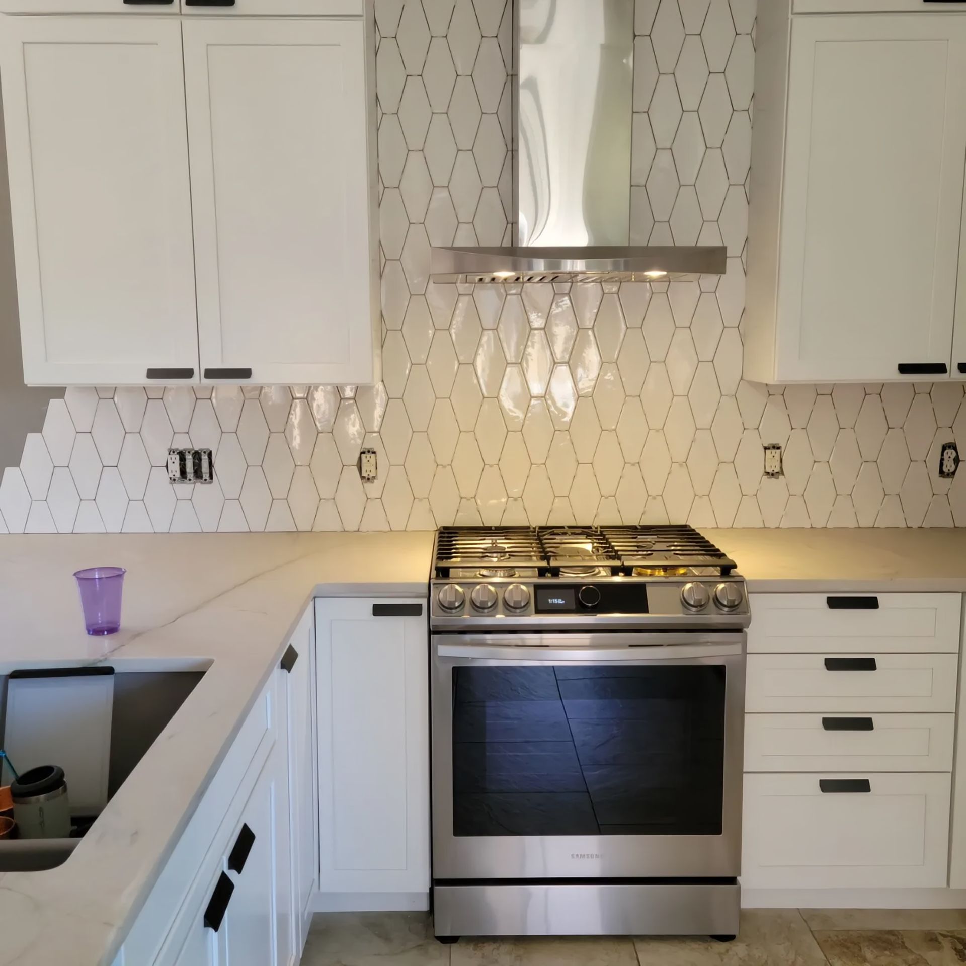 a modern kitchen with black cabinets , wooden counter tops and stools .