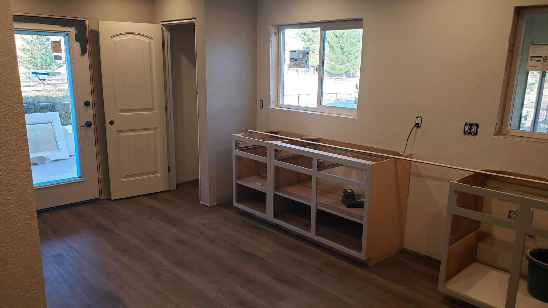 a living room under construction with a lot of tools on the floor .