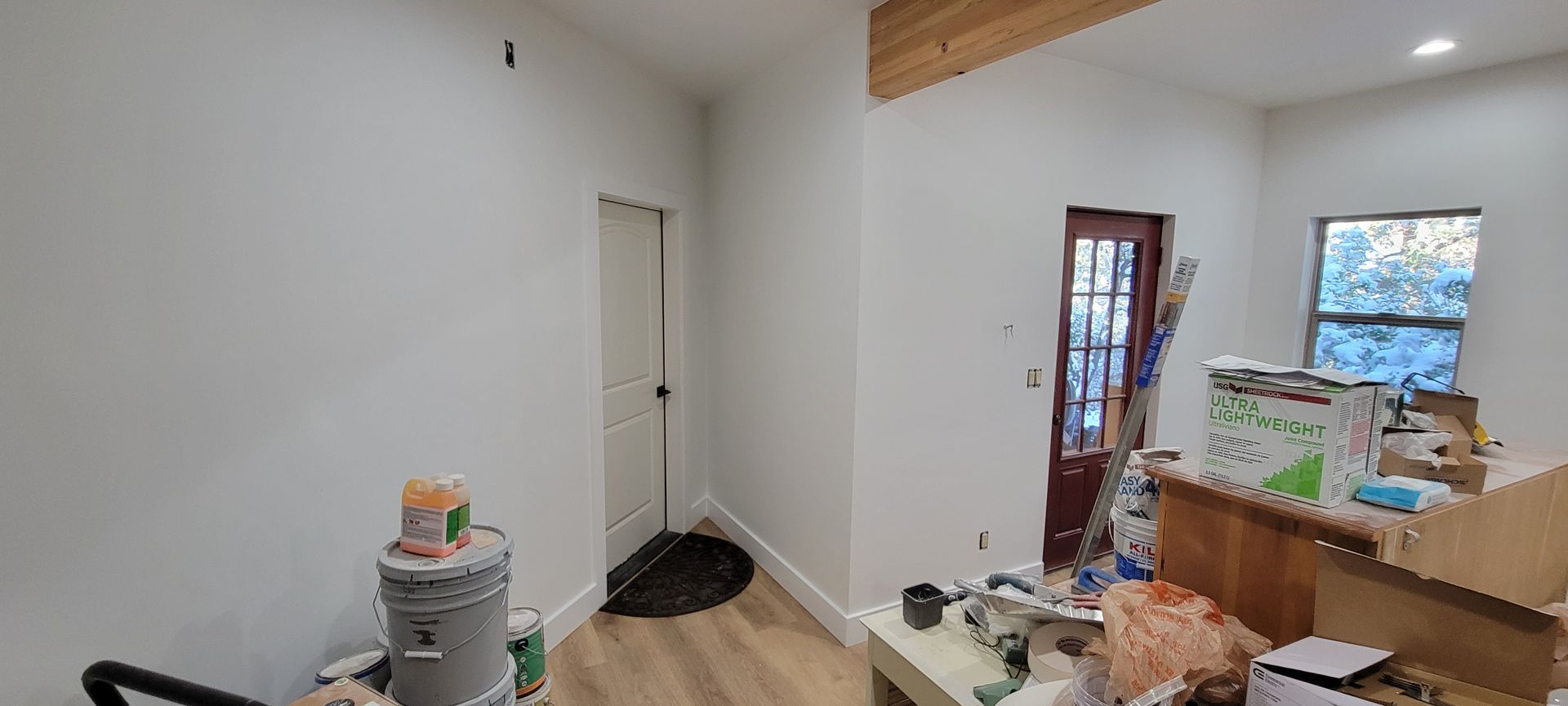 a kitchen is being remodeled with a refrigerator in the middle of the room .