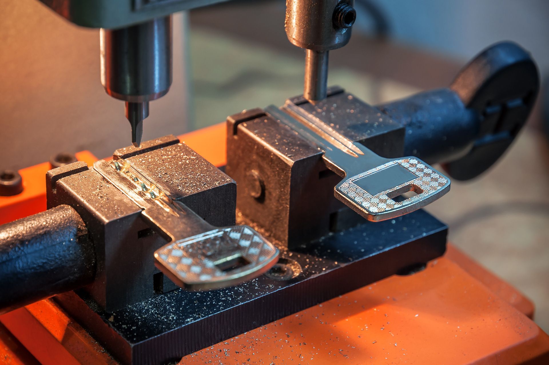 Key-cutting machine in use, duplicating a decorative key with a drilling tool