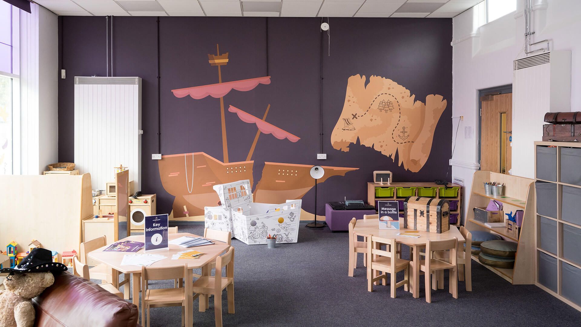 Two young boys are sitting on a couch reading books.
