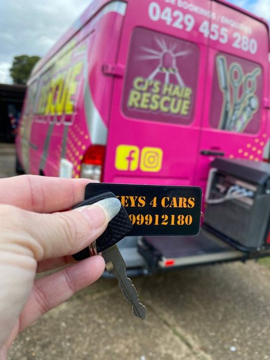 Car key with Tag Background Pink Van — Automotive Locksmith in Wagga Wagga, NSW