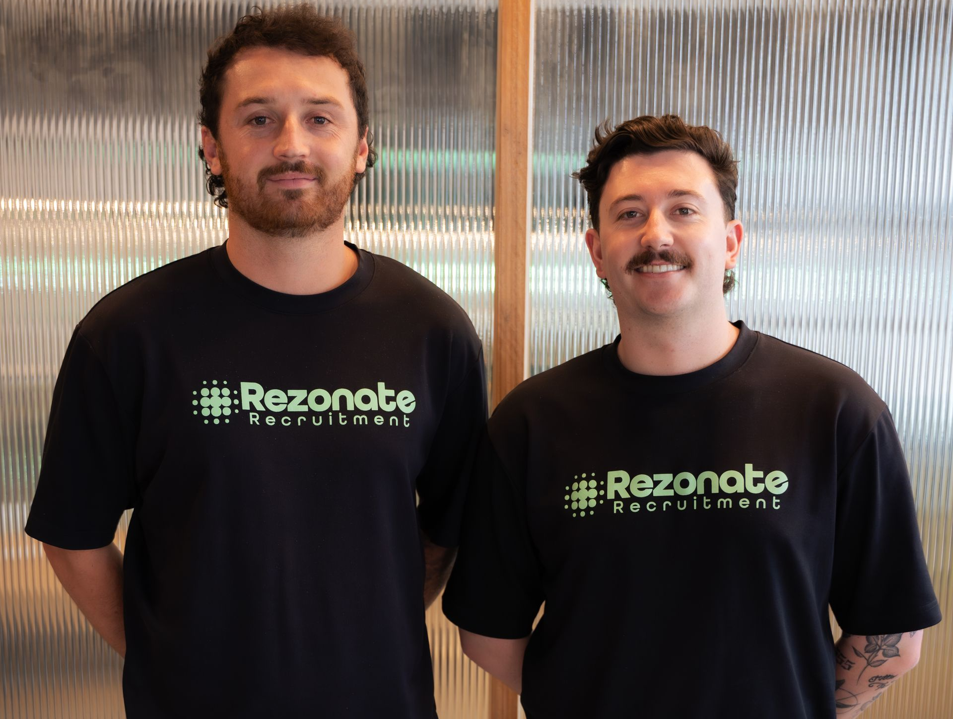 Two men in black t-shirts with 