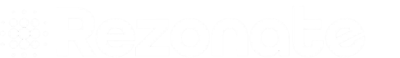 Faint, blurry image of what appears to be writing or a logo in white on a white background.