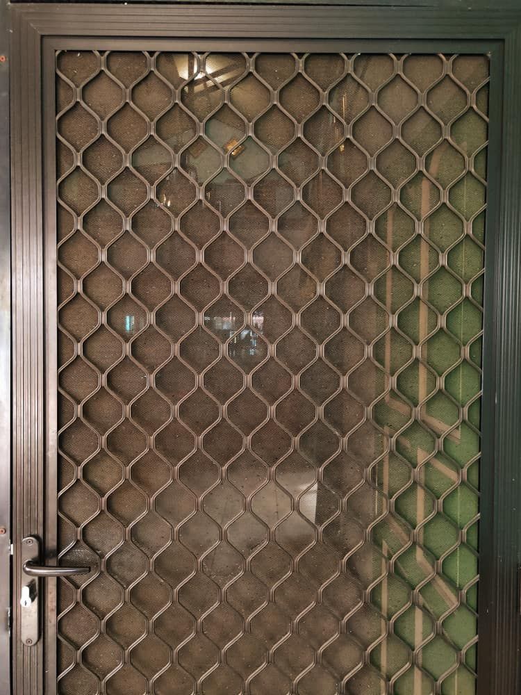 A Metal Gate With A Grid Pattern On It — Browny's Glass & Aluminium in Wingham, NSW