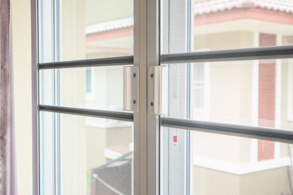 A Sliding Glass Door With A Screen — Browny's Glass & Aluminium in Harrington, NSW