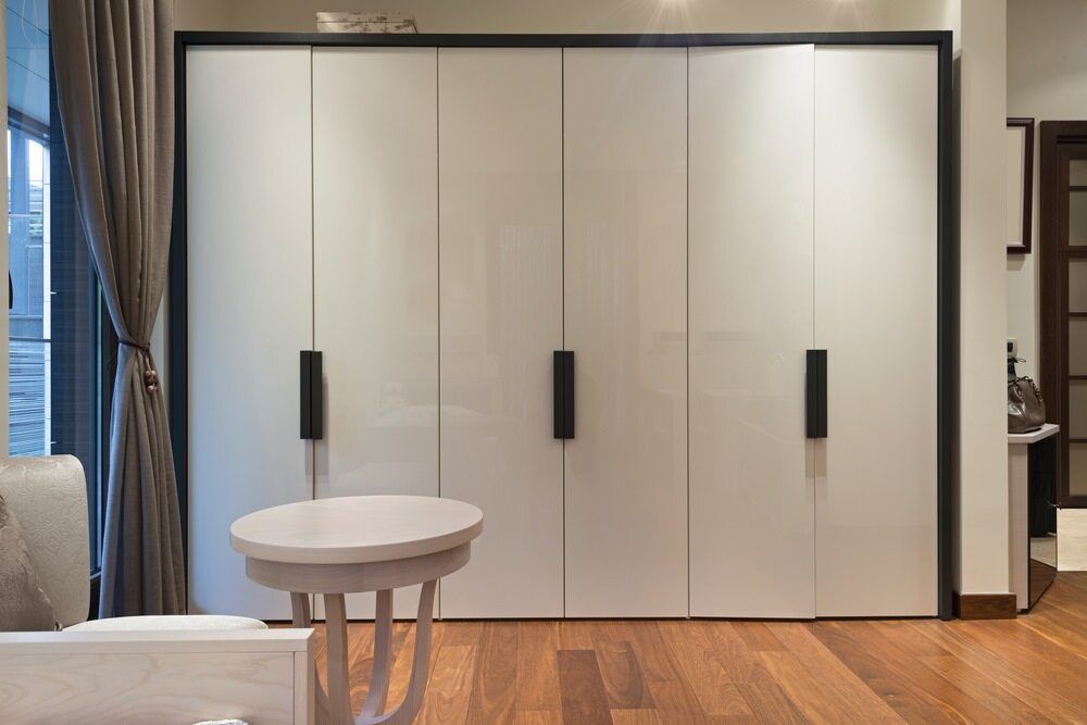 A Living Room With A Large Wardrobe And A Table — Browny's Glass & Aluminium in Wingham, NSW