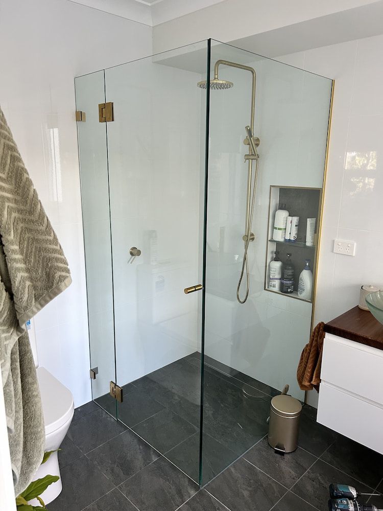 A Bathroom With A Walk In Shower And A Toilet — Browny's Glass & Aluminium in Wingham, NSW