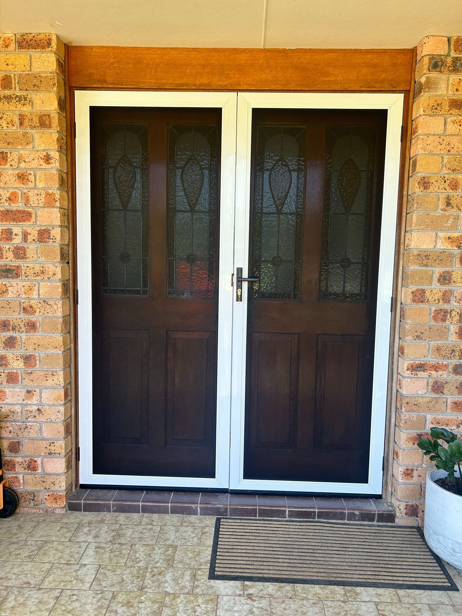 A Fence Is Visible Through A Sliding Glass Door — Browny's Glass & Aluminium in Old Bar, NSW