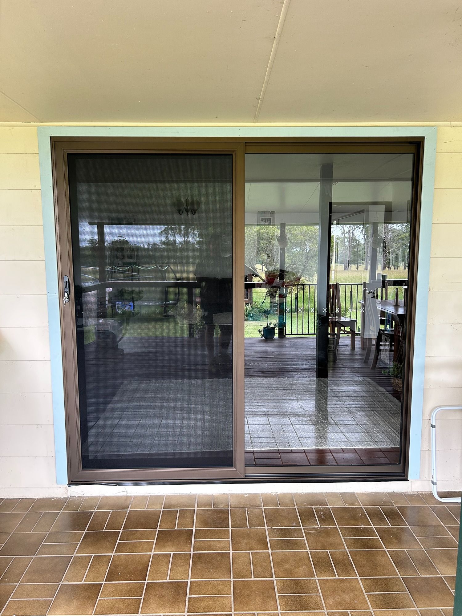 A Door With A Wrought Iron Gate And Orange Trim On A Building — Browny's Glass & Aluminium in Old Bar, NSW