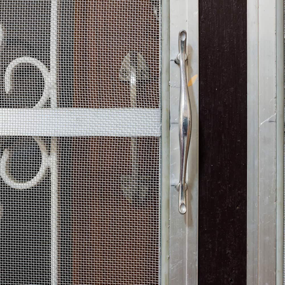 A Metal Screen Door With A Handle — Browny's Glass & Aluminium in Gloucester, NSW