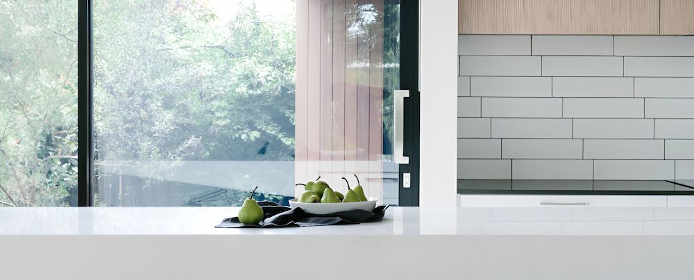 A Bowl Of Pears Is Sitting On A Counter In A Kitchen — Browny's Glass & Aluminium in Wingham, NSW