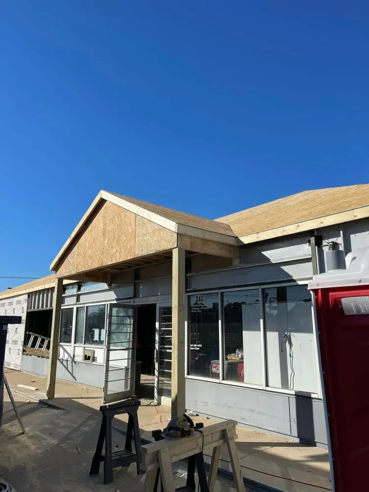 A house is being built with a blue sky in the background.