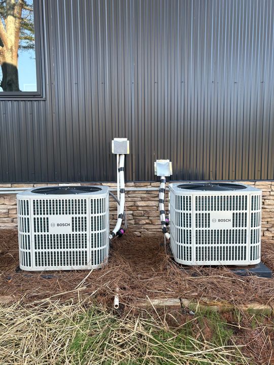 A basement with a water heater and a furnace.