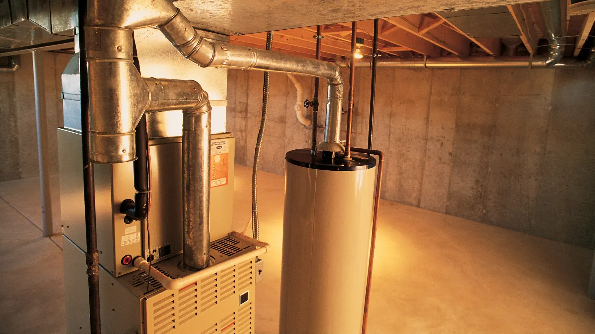 A basement with a water heater and a furnace.