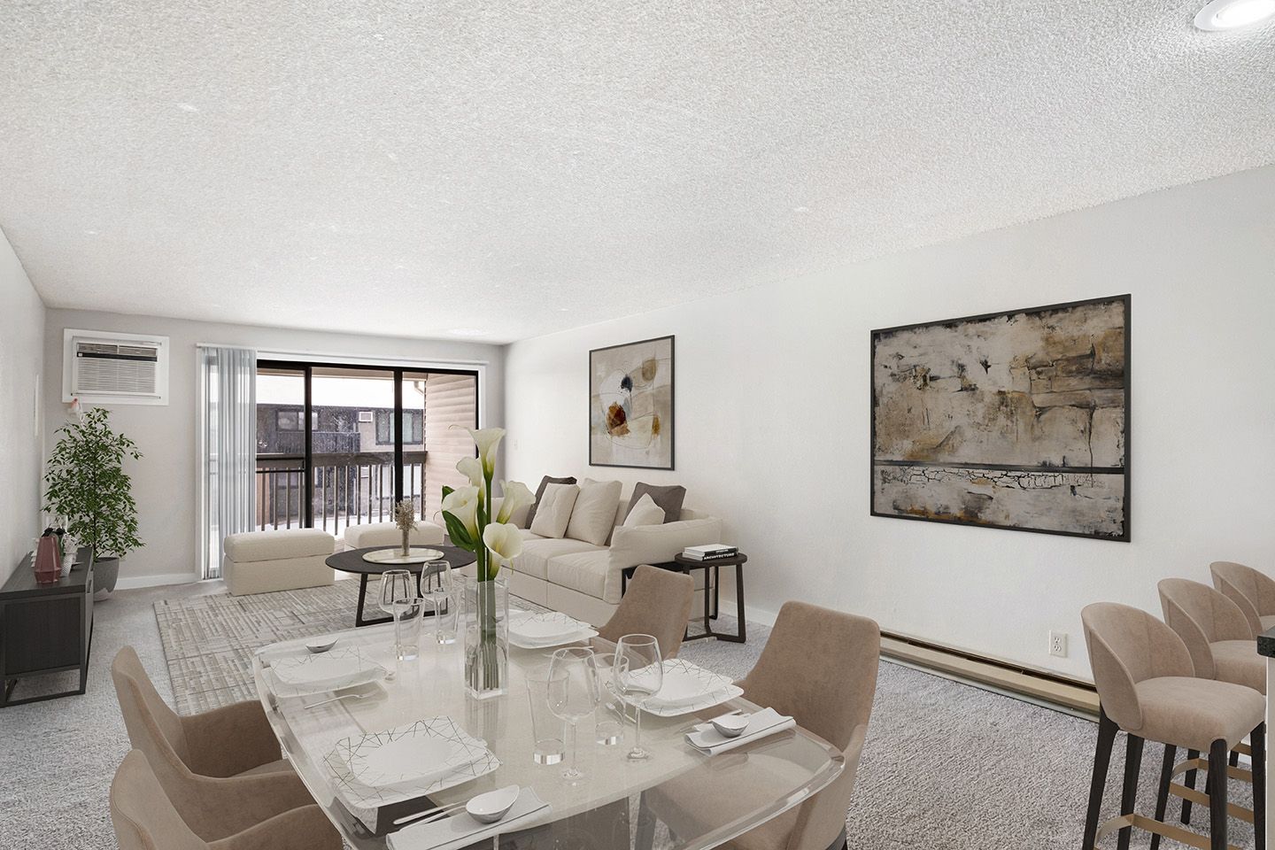 Bright modern living-dining room with beige furniture, glass table, artwork, and balcony doors