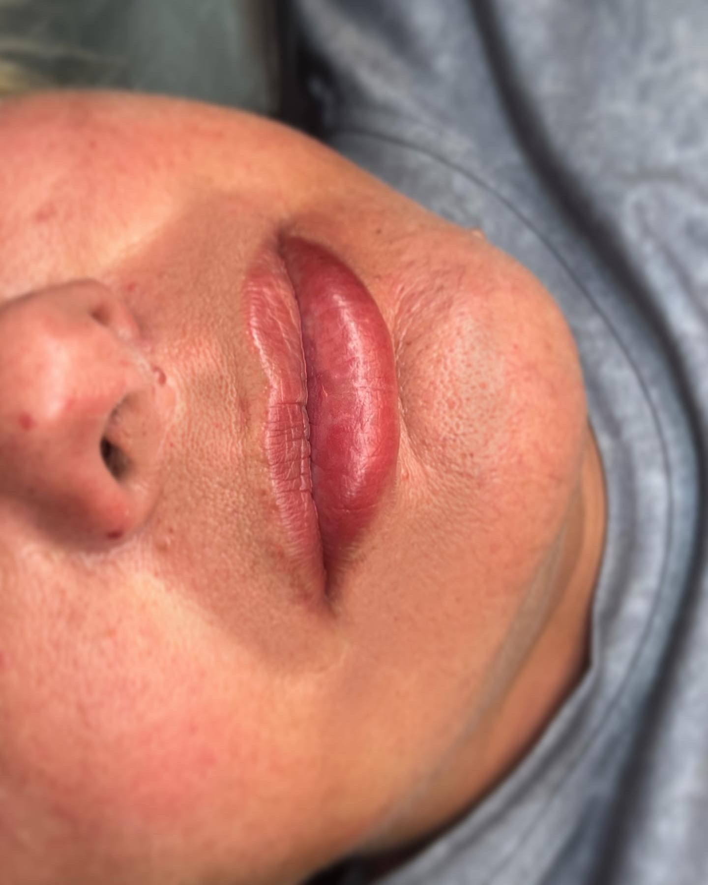 A close up of a woman 's face with red lips.