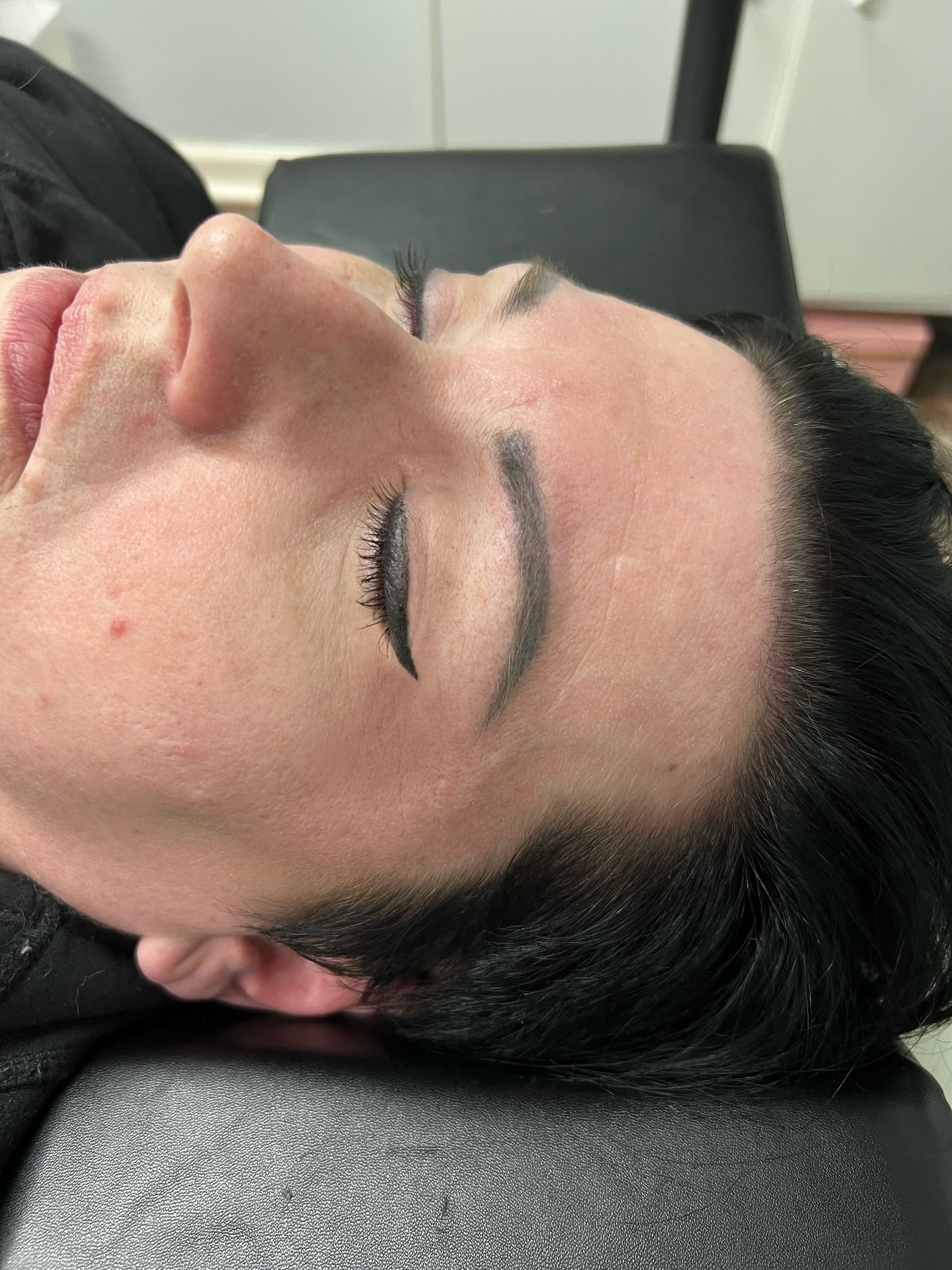 A close up of a person 's face with their eyes closed.