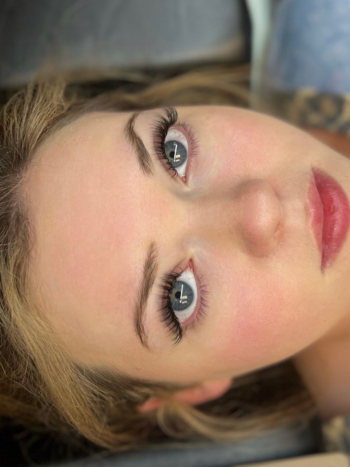 A close up of a woman 's face with her eyes closed.