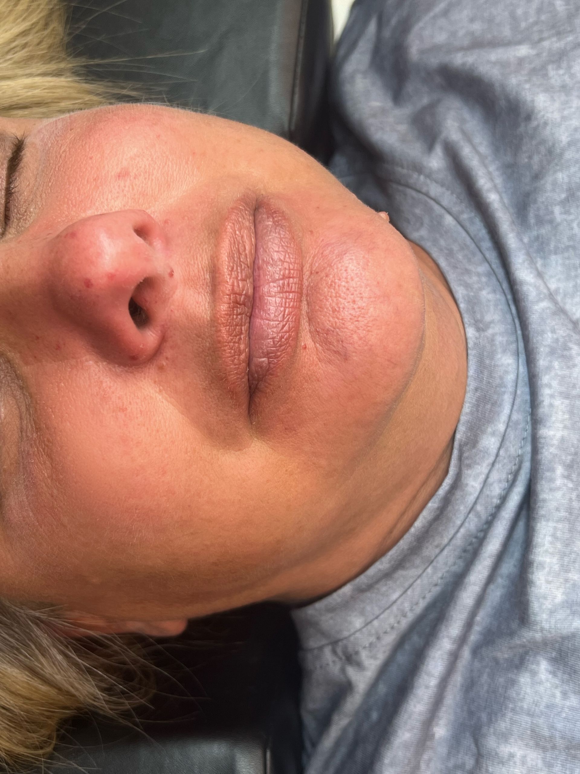 A close up of a woman 's face with her eyes closed.