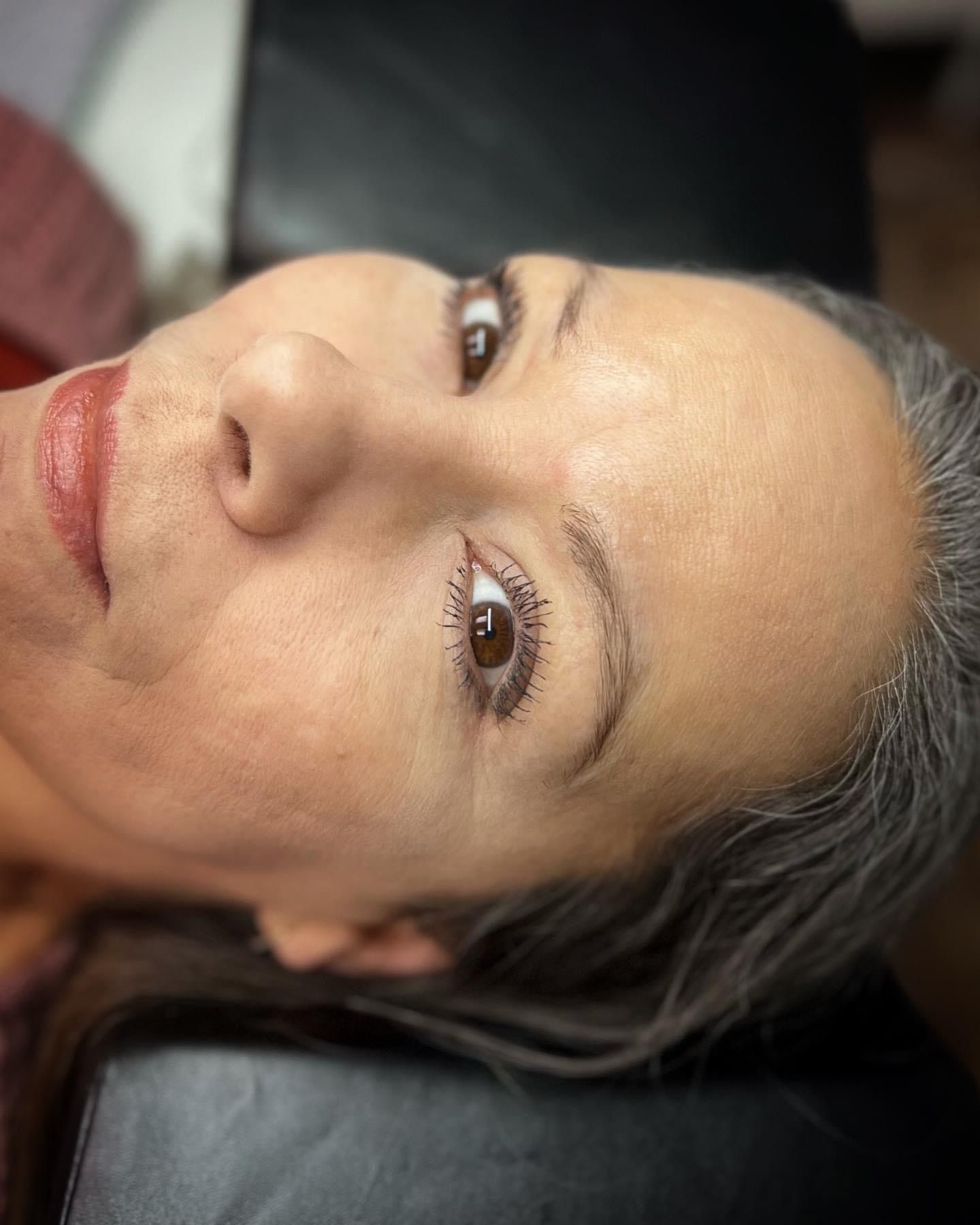 A close up of a woman 's face with her eyes closed.