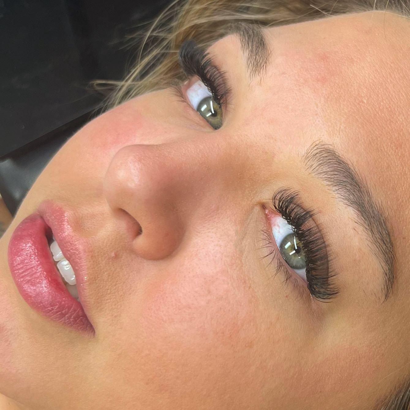A close up of a woman 's face with long eyelashes