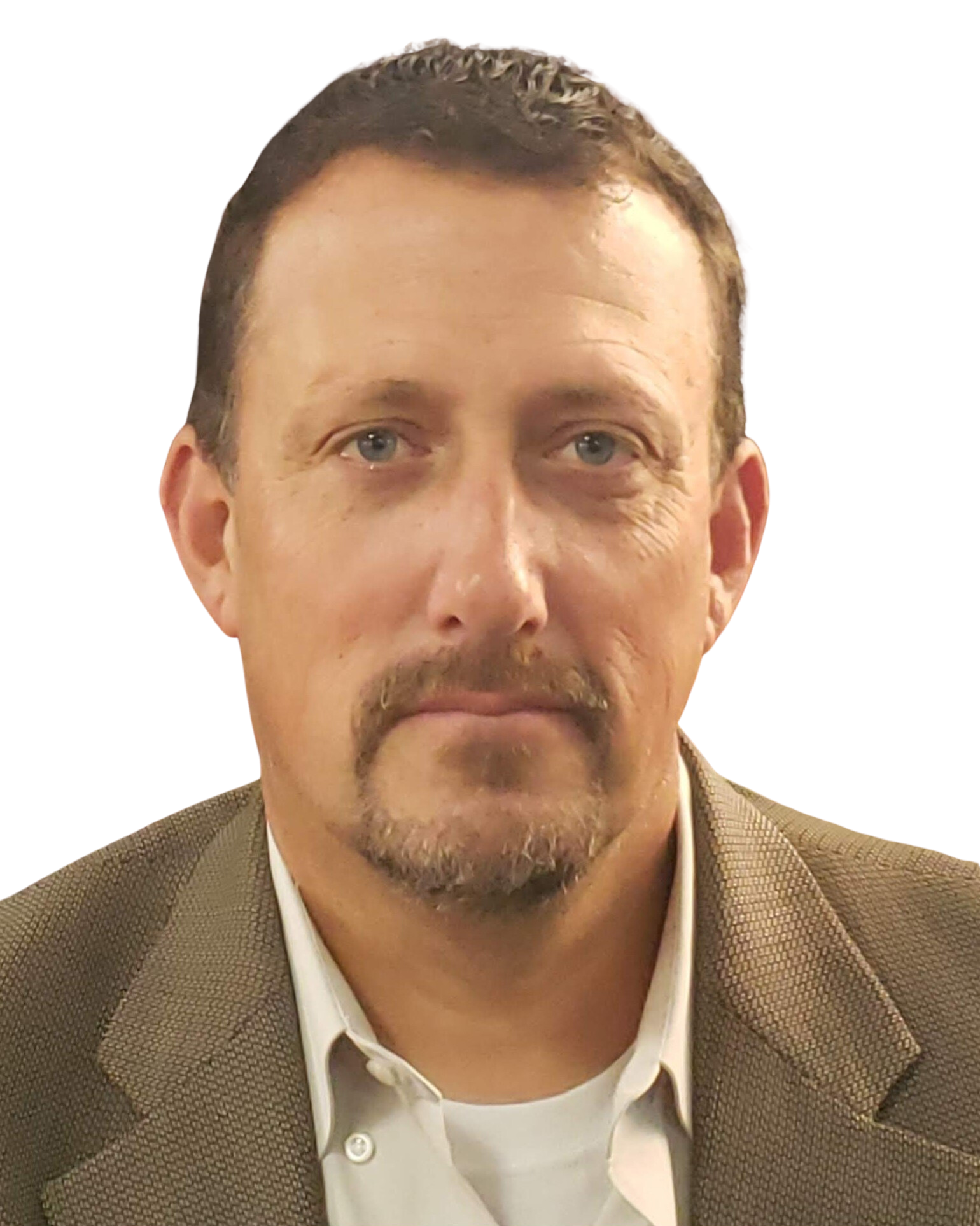 A man with a beard is wearing a suit and white shirt.