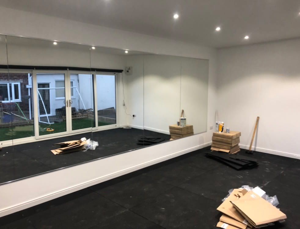 Large mirror wall and glass bifold doors in new property extension
