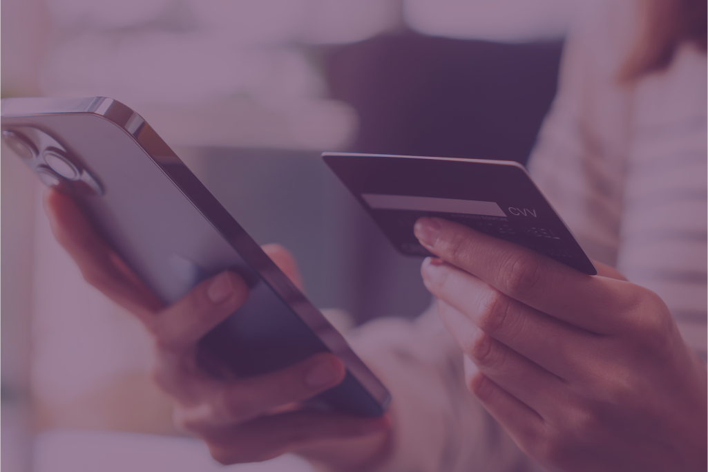A man and a woman are sitting at a desk in front of a computer.