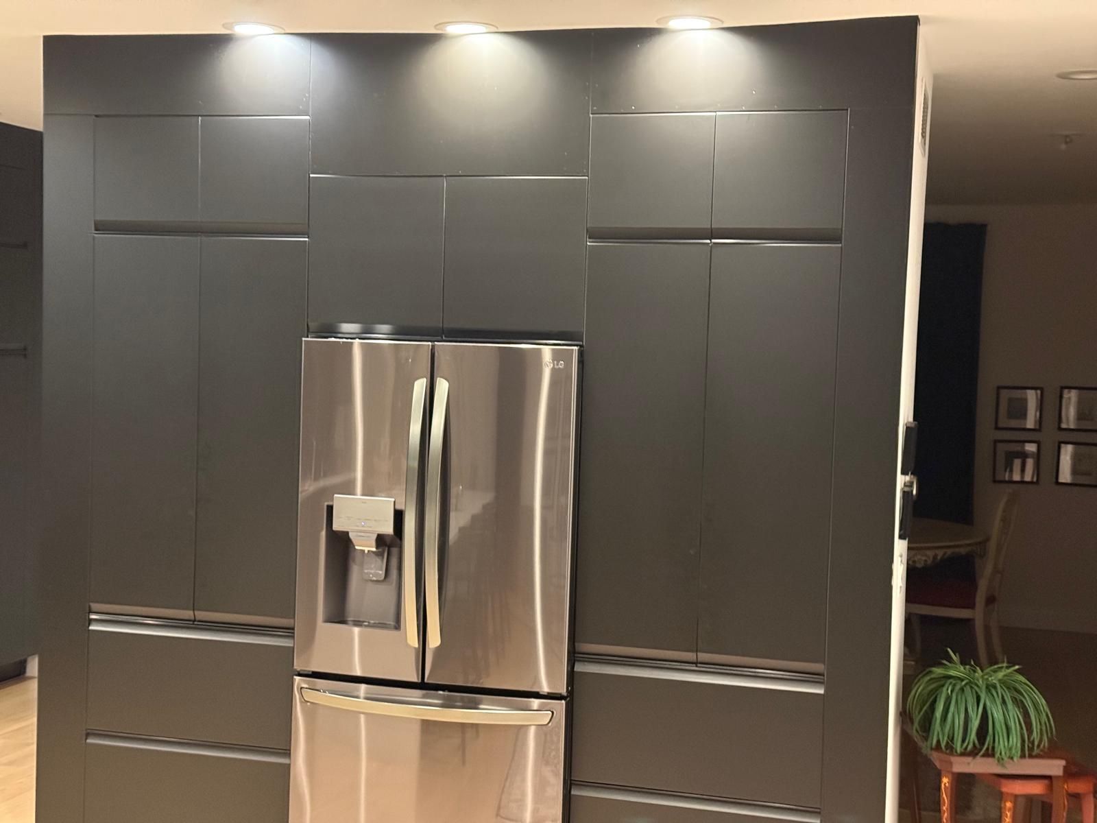 Custom cabinetry around a refrigerator in a client's kitchen