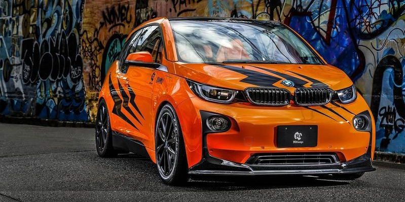 Een oranje BMW i3 in 3D ontwerp is voorzien van blitse stickers