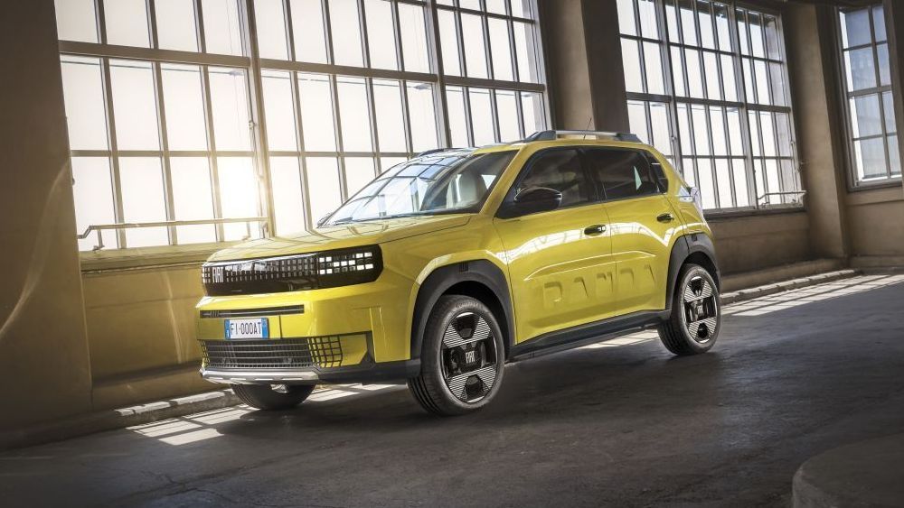Een gele Fiat Grande Panda staat in een oude fabriekshal 