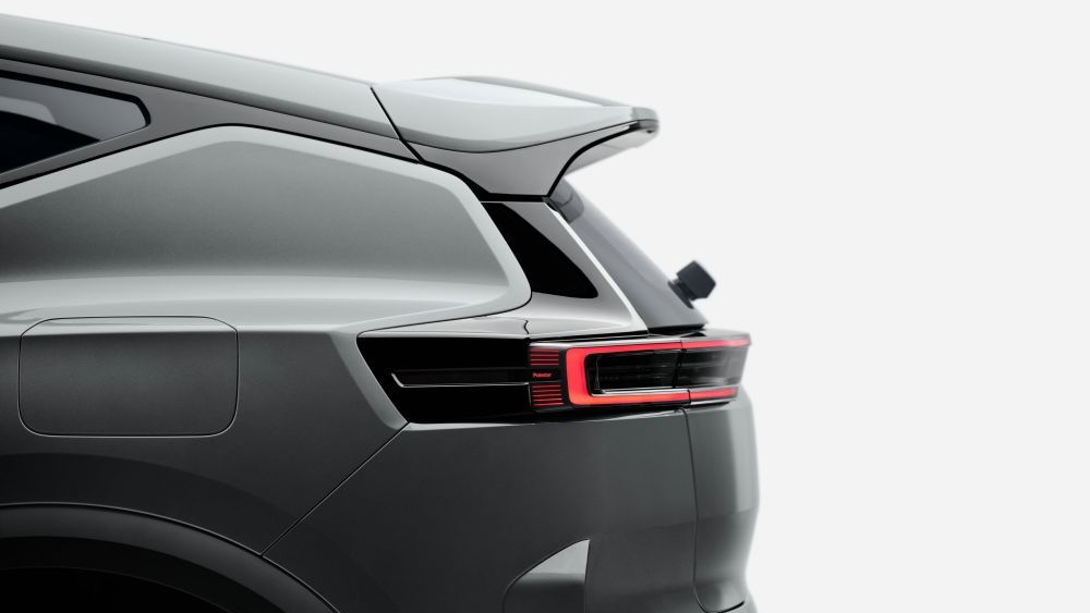 Rear view of a gray Polestar 3 with a spoiler and a red taillight.