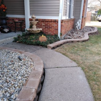 A brick house with a stone walkway leading to it