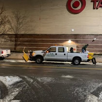 A snow plow is parked in front of a target store.