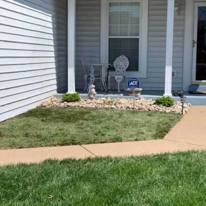 A house with a porch and a sign that says adt on it