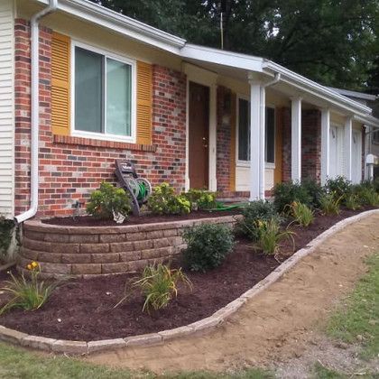 A brick house with a lawn mower in front of it